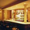 bar with mirror back glass shelves in basement